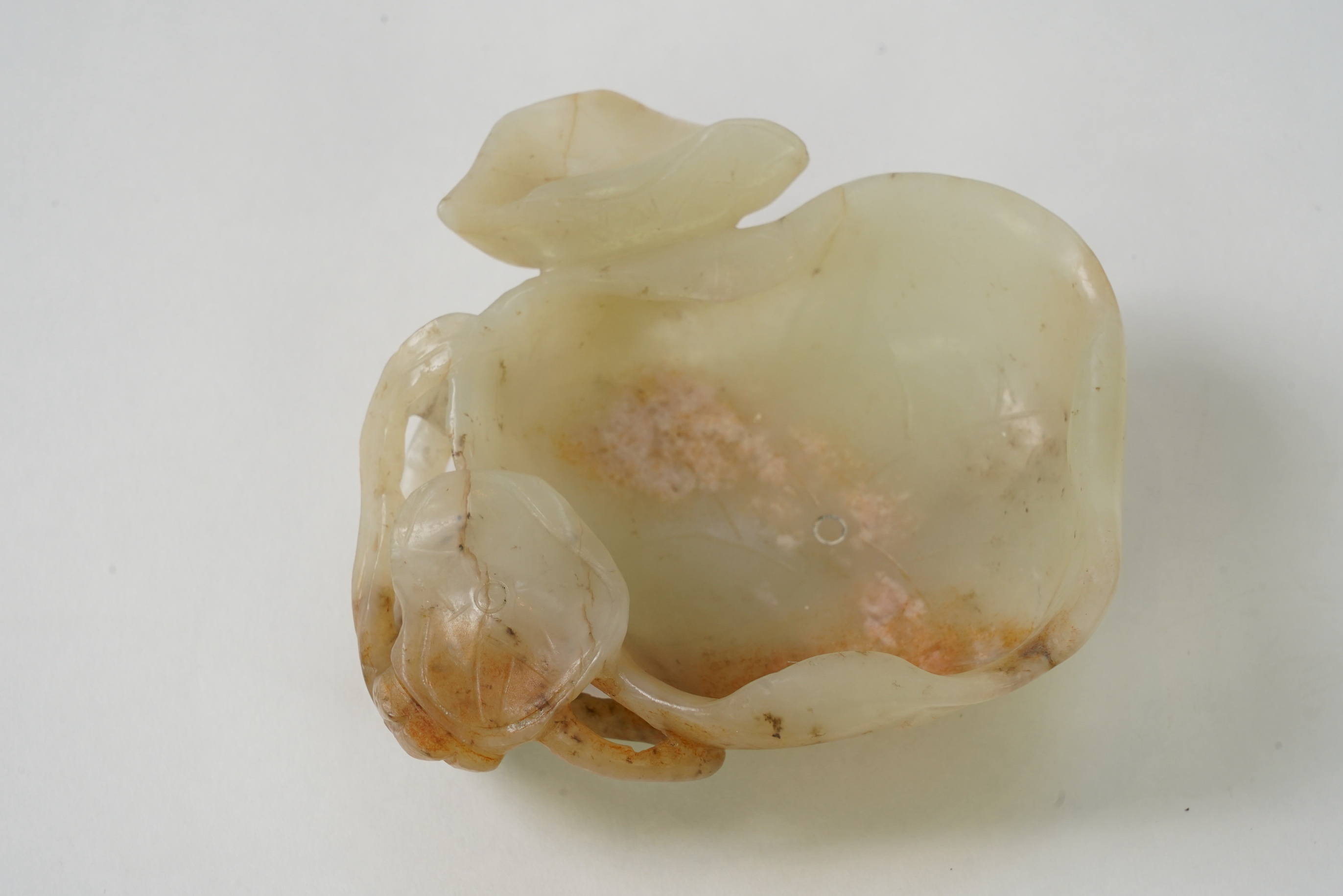 A Chinese pale celadon and russet jade brushwasher, Ming dynasty, 16th/17th century